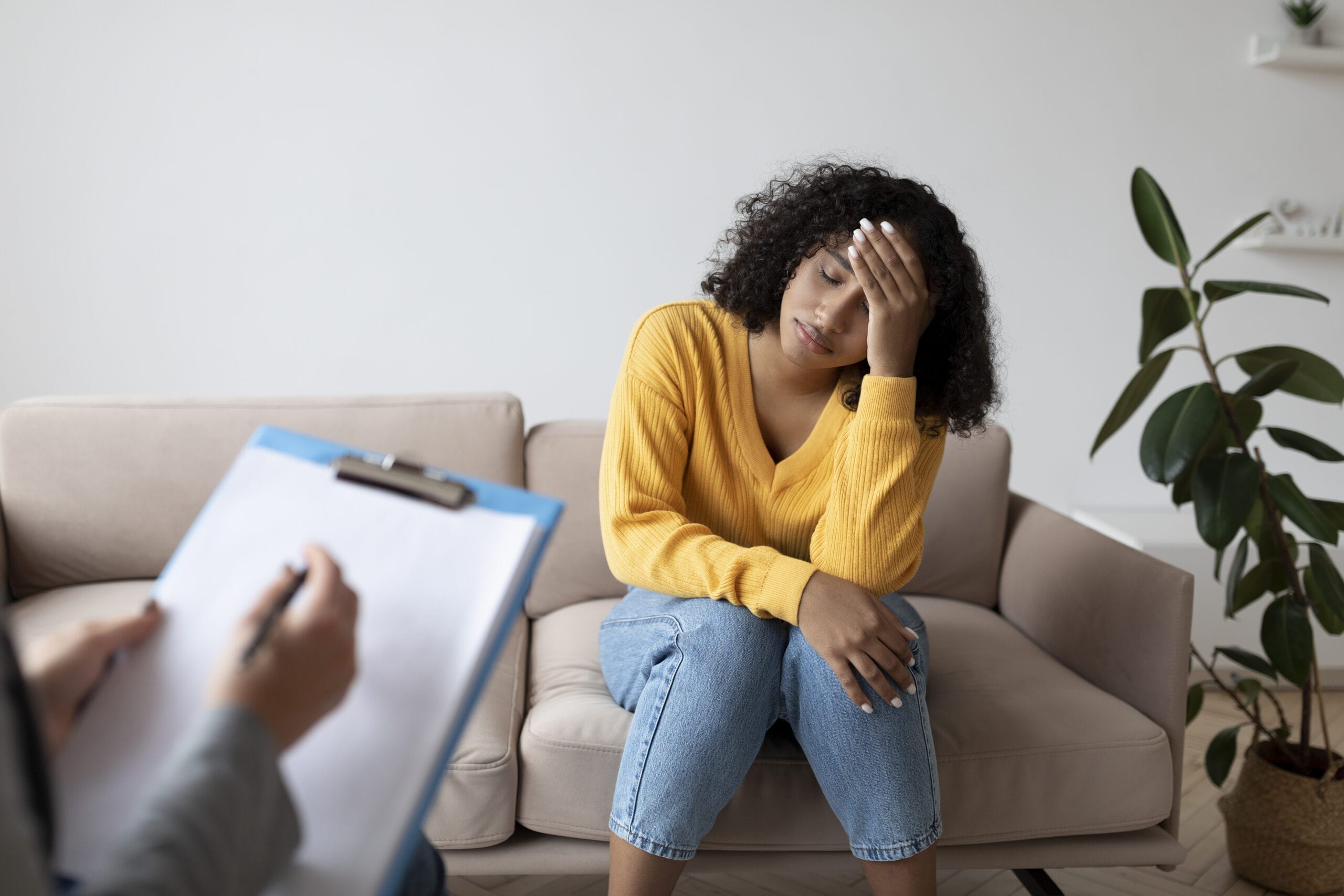 Depressed black woman having consultation with psychologist suffering from PTSD at mental clinic Acceptance Path Counseling Breaking the anxiety loop with specialized therapists in the woodlands