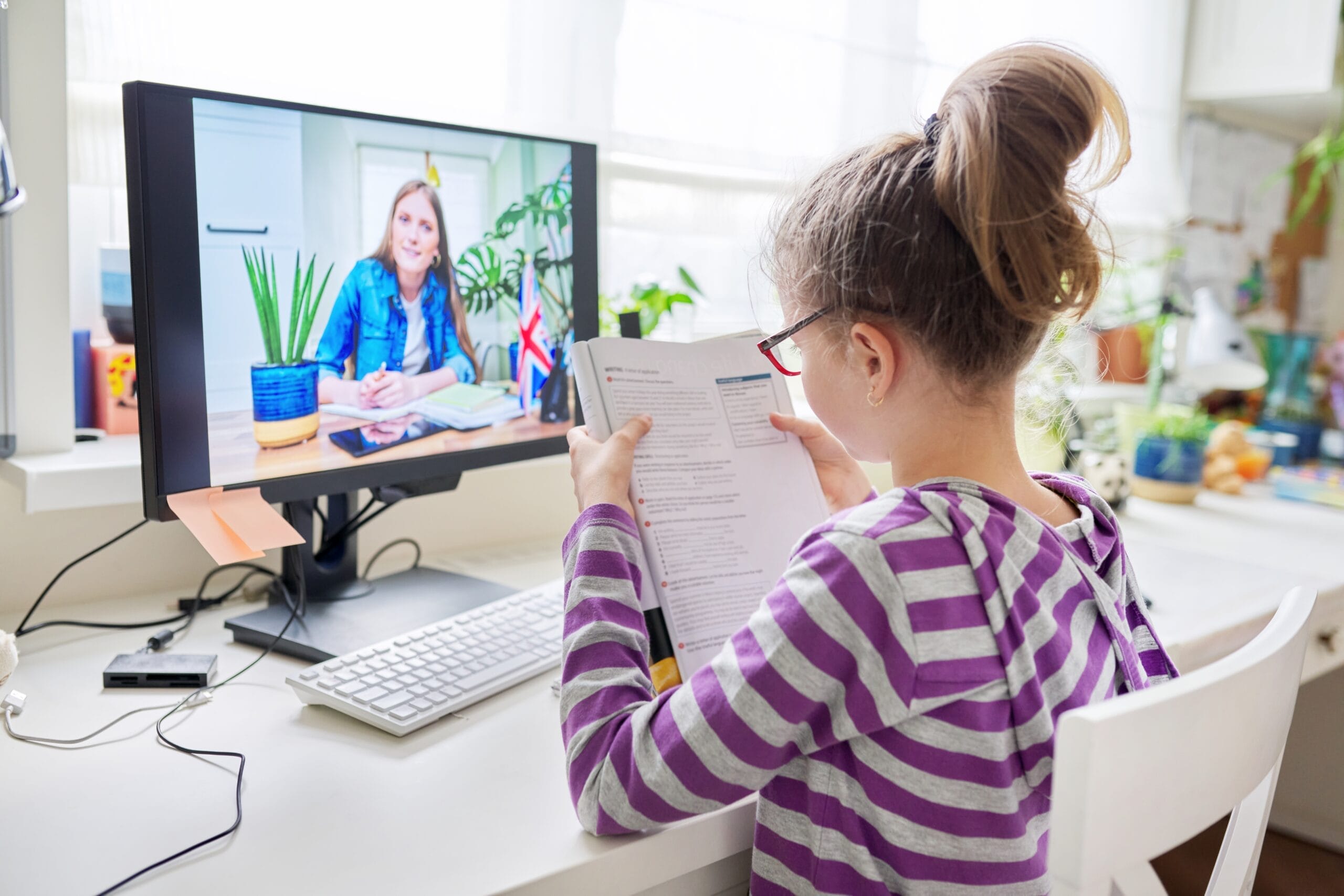 Online learning little student girl learning language remotely with an English teacher Acceptance Path Counseling A child on a telehealth call illustrating the convenience trap of ADHD treatment online for families in the Rayford corridor