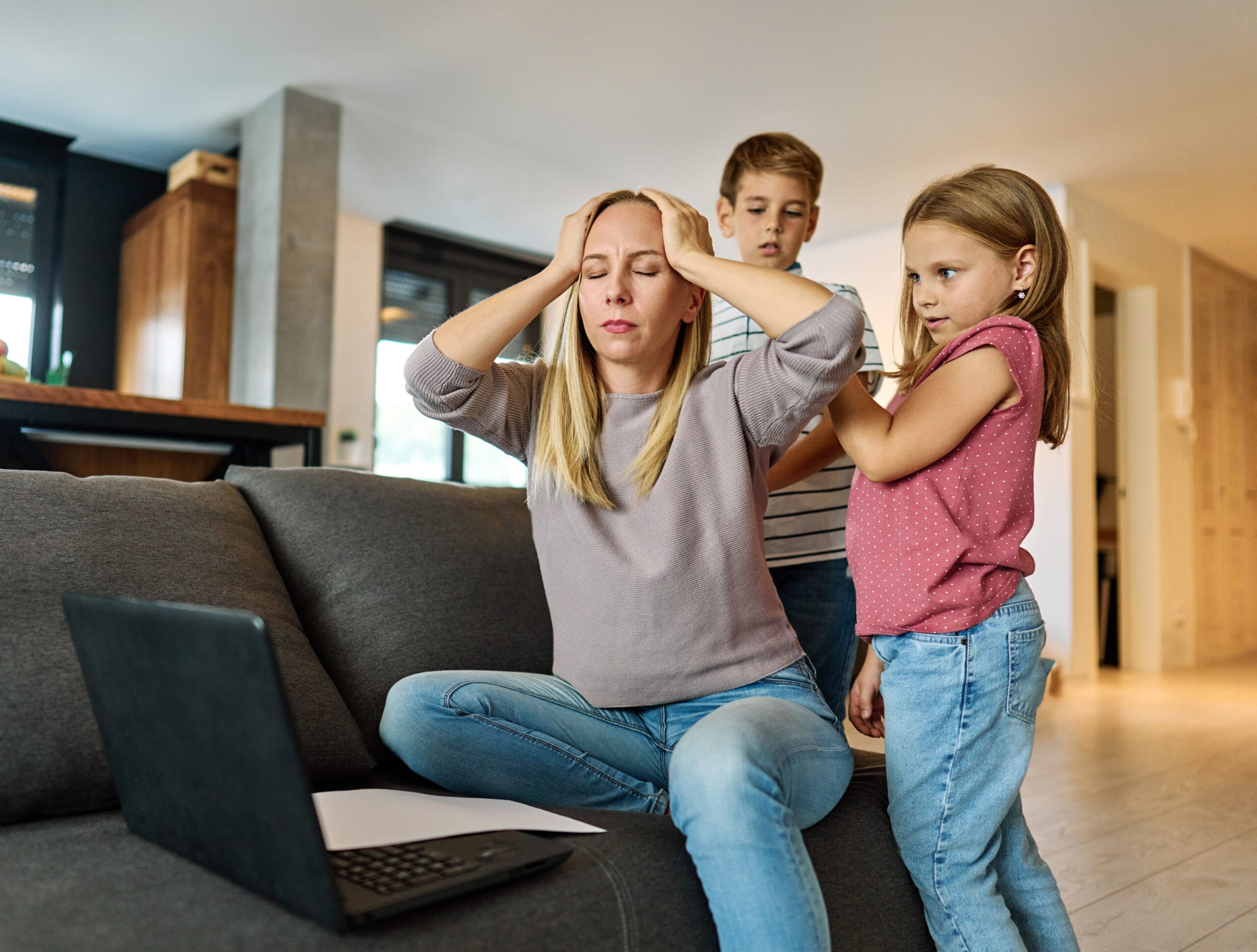 A mother experiencing stress with her children during an emotional outburst