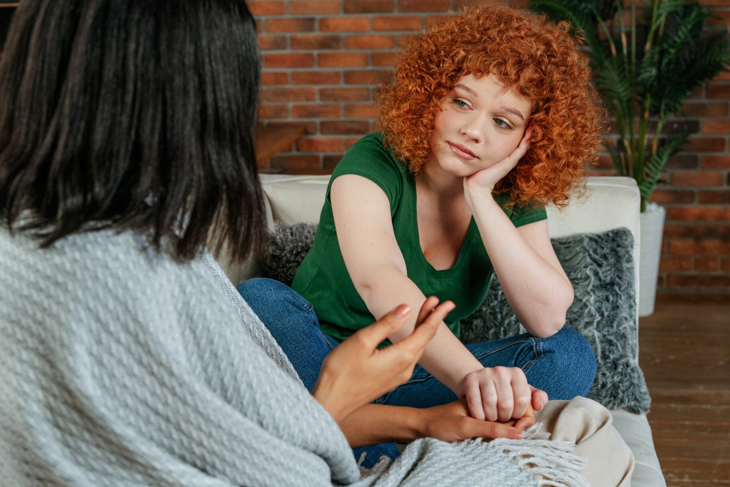 A woman with curly red hair receives support highlighting a holistic approach after a borderline personality disorder test This care helps Panther Creek residents focus on overall wellbeing in The Woodlands
